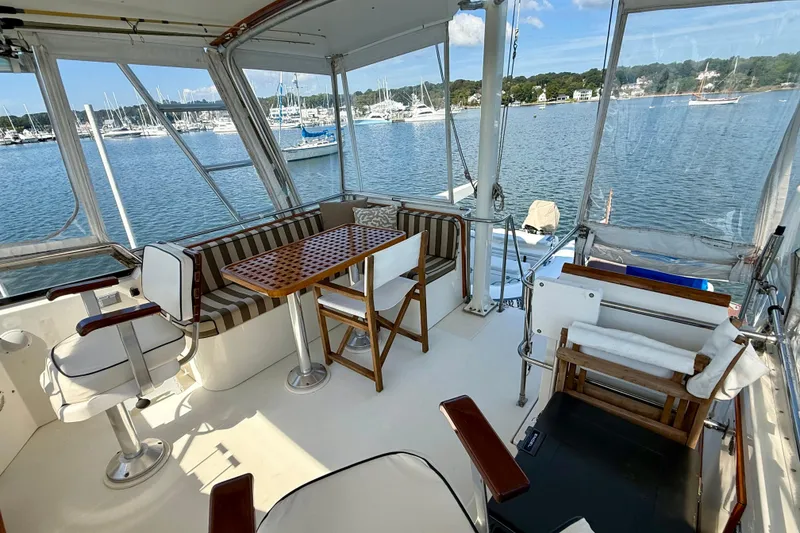 Slide: The Image of Spacious deck of 1997 Sabreline 47 yacht with seating and scenic marina view. - 33