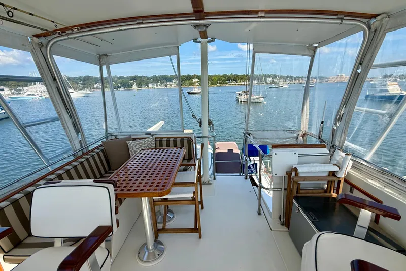 Slide: The Image of 1997 Sabre Sabreline 47 yacht interior with seating area and scenic marina view. - 34