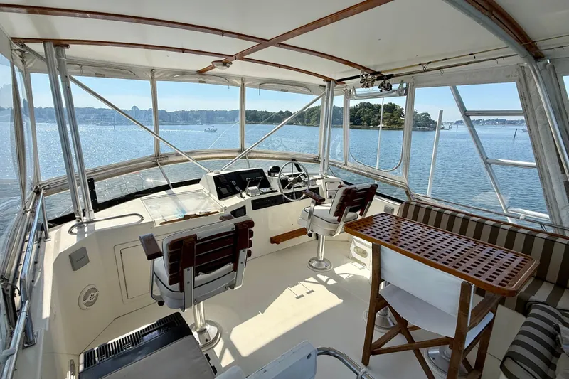 Slide: The Image of 1997 Sabre Sabreline 47 yacht interior with helm, seating, and ocean view. - 36