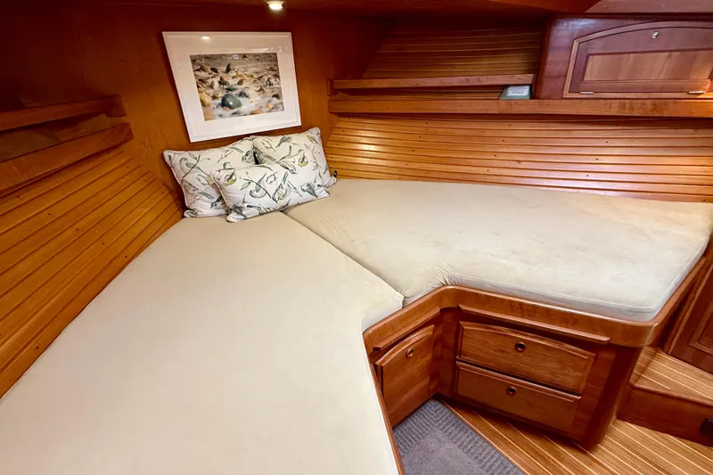 Slide: The Image of Cozy cabin interior of 1997 Sabreline 47 yacht with wooden paneling and comfortable bedding. - 39