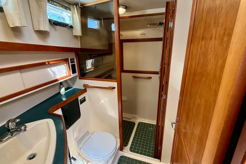 Slide: The Image of Bathroom interior of 1997 Sabreline 47 yacht with sink, toilet, and shower. - 42