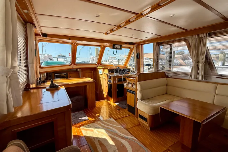 Slide: The Image of Luxurious interior of 1997 Sabreline 47 yacht with wood finish and spacious seating area. - 56