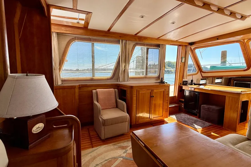 Slide: The Image of Interior of 1997 Sabreline 47 yacht with wooden furnishings and large windows. - 58