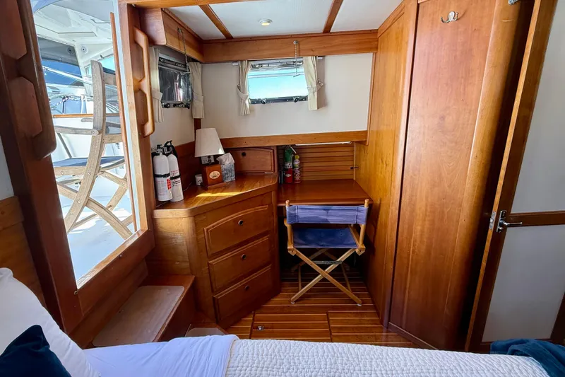 Slide: The Image of Cozy cabin interior of 1997 Sabreline 47 yacht with wooden furnishings and window view. - 67