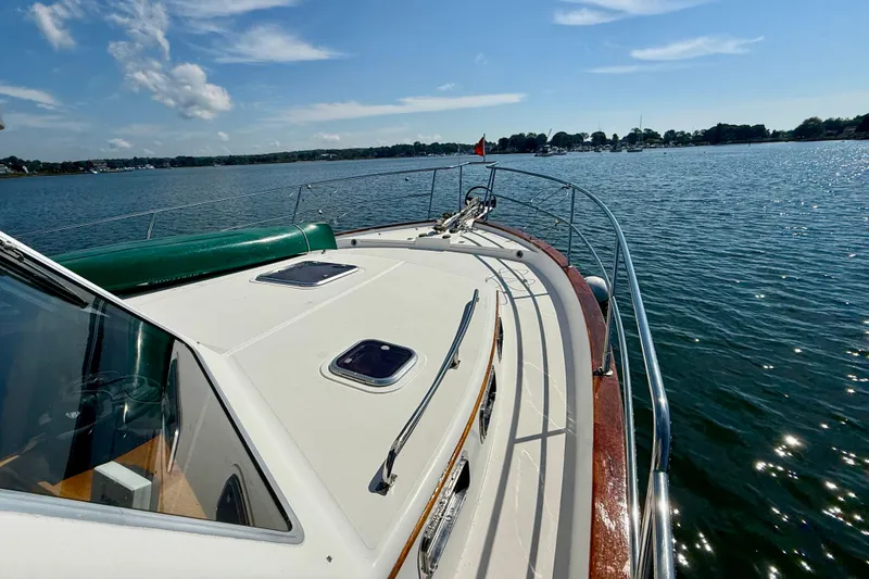 Slide: The Image of 1997 Sabre Sabreline 47 yacht on calm water under a clear blue sky. - 14