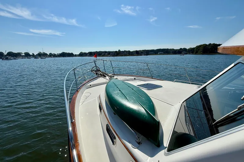 Slide: The Image of 1997 Sabre Sabreline 47 yacht on calm water, featuring a kayak on deck. - 15