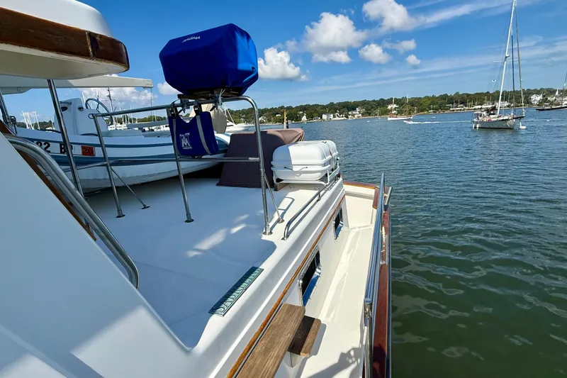 Slide: The Image of 1997 Sabre Sabreline 47 yacht docked in a scenic marina with sailboats. - 25