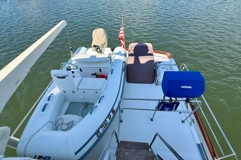 Slide: The Image of 1997 Sabre Sabreline 47 yacht with inflatable boat and Magma grill on deck. - 31