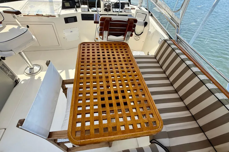 Slide: The Image of 1997 Sabre Sabreline 47 yacht interior with striped seating and wooden table. - 35