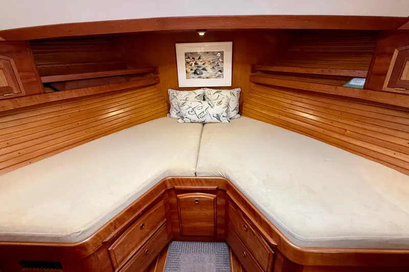 Slide: The Image of 1997 Sabre Sabreline 47 yacht cabin with wooden interior and cozy bedding. - 40