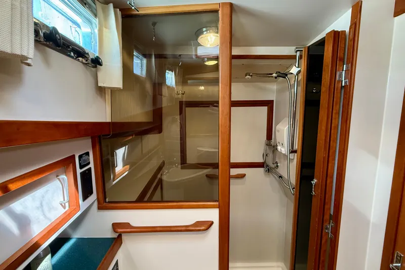 Slide: The Image of Interior of 1997 Sabre Sabreline 47 yacht bathroom with wooden accents and shower. - 43