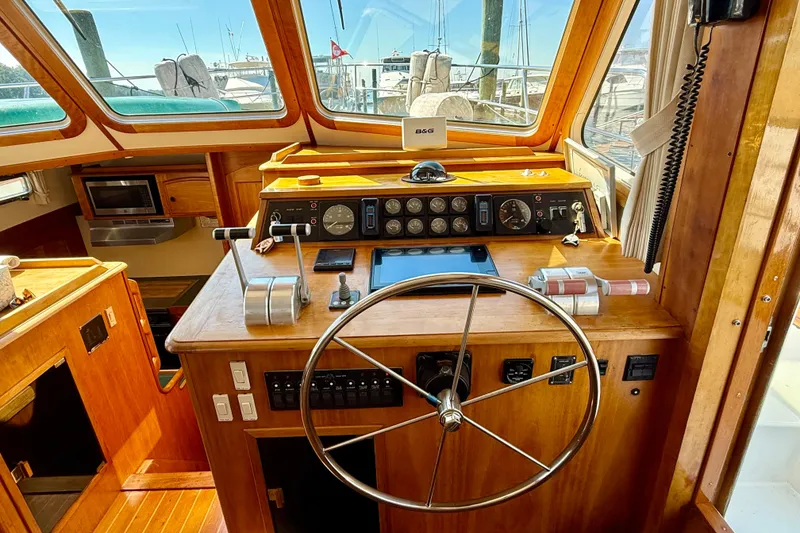 Slide: The Image of 1997 Sabre Sabreline 47 yacht helm with wooden dashboard and steering wheel. - 53