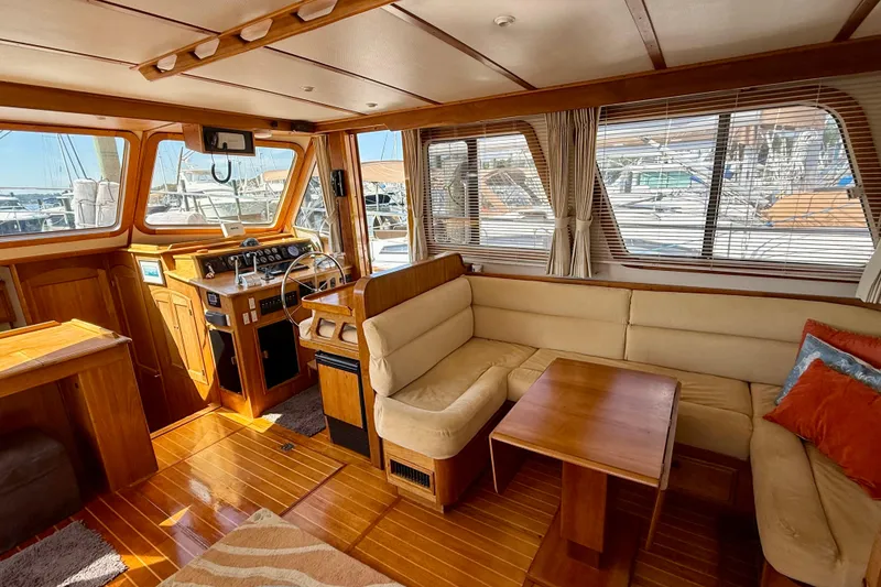 Slide: The Image of Interior of 1997 Sabre Sabreline 47 yacht with wooden finishes and beige seating. - 60