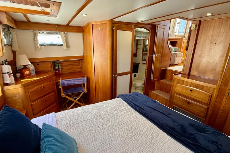 Slide: The Image of Luxurious 1997 Sabreline 47 yacht interior with wooden cabinetry and cozy bedroom. - 66