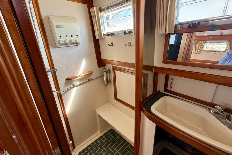 Slide: The Image of 1997 Sabre Sabreline 47 yacht bathroom with wooden accents and modern fixtures. - 69