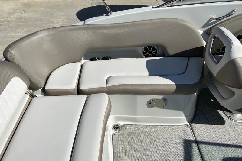 Slide: The Image of 2021 Crownline Eclipse E235 XS boat interior with cushioned seating and speaker. - 10