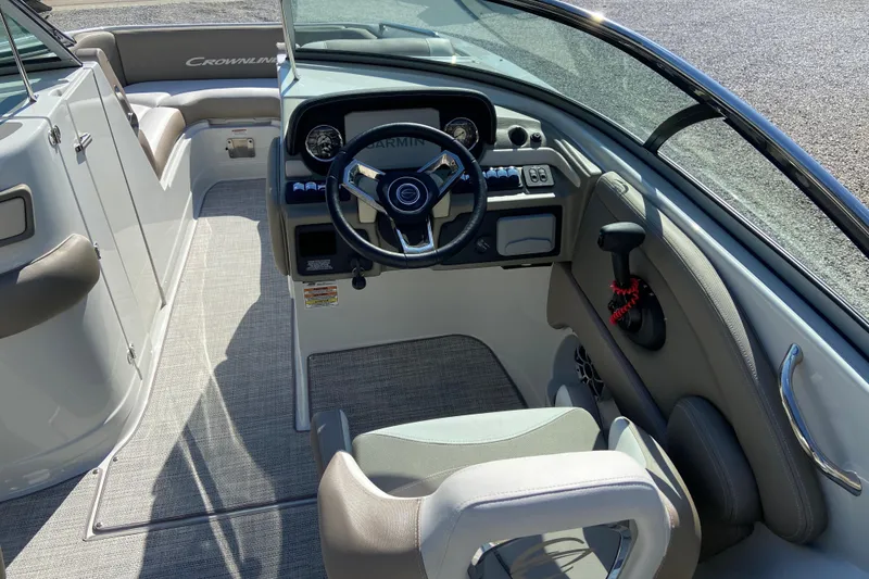 Slide: The Image of 2021 Crownline Eclipse E235 XS boat interior with steering wheel and dashboard controls. - 12
