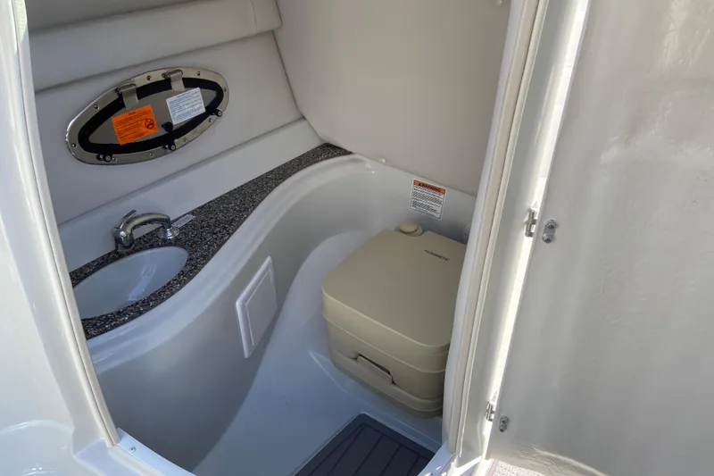 Slide: The Image of 2021 Crownline Eclipse E235 XS boat interior with sink and portable toilet. - 13