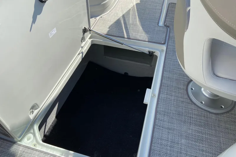 Slide: The Image of 2021 Crownline Eclipse E235 XS boat storage compartment with open hatch. - 14