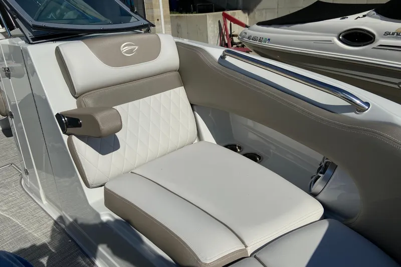 Slide: The Image of Luxurious seating on 2021 Crownline Eclipse E235 XS boat, featuring elegant upholstery and armrest. - 15