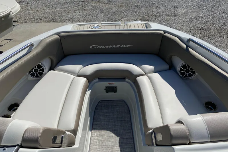 Slide: The Image of 2021 Crownline Eclipse E235 XS boat interior with cushioned seating and speakers. - 16