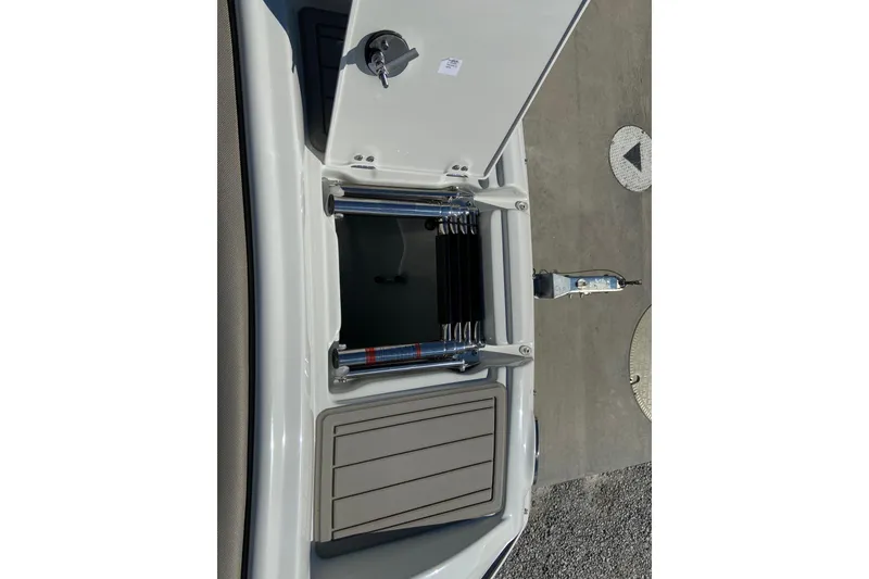 Slide: The Image of 2021 Crownline Eclipse E235 XS boat ladder compartment, open view. - 17