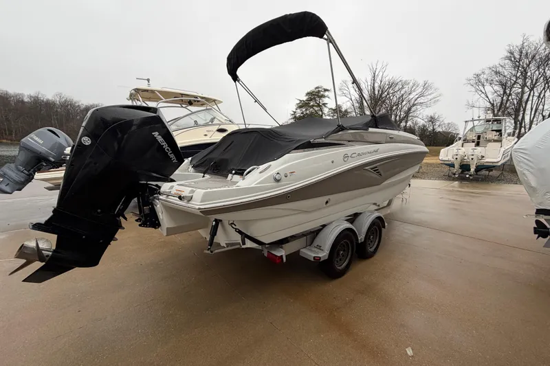 Slide: The Image of 2021 Crownline Eclipse E235 XS boat on trailer with Mercury outboard motor. - 2