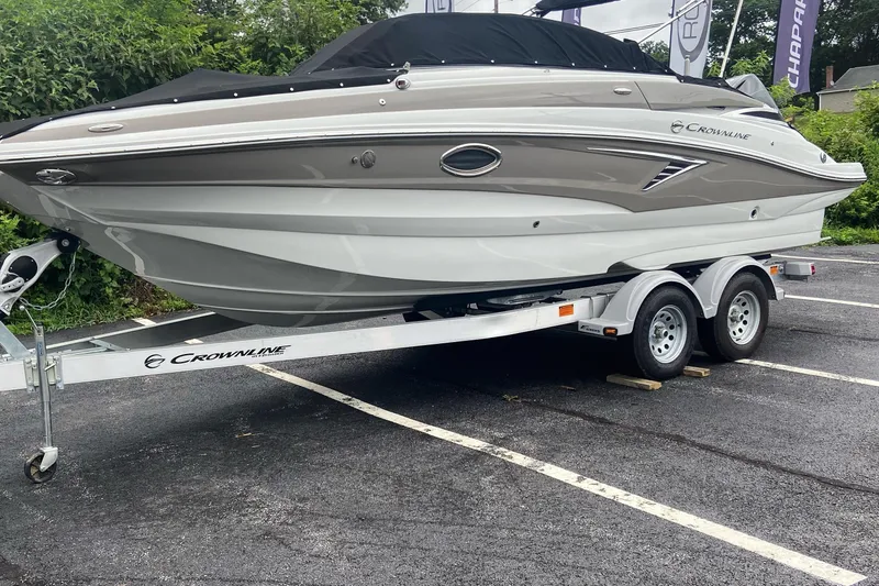 Slide: The Image of 2021 Crownline Eclipse E235 XS boat on trailer, parked in a lot. - 4