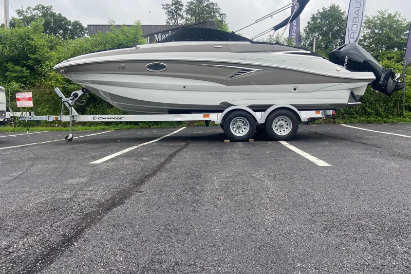 Slide: The Image of 2021 Crownline Eclipse E235 XS boat on trailer in parking lot. - 5