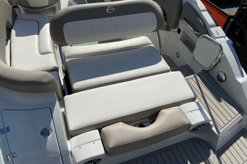 Slide: The Image of 2021 Crownline Eclipse E235 XS boat interior with cushioned seating and sleek design. - 8