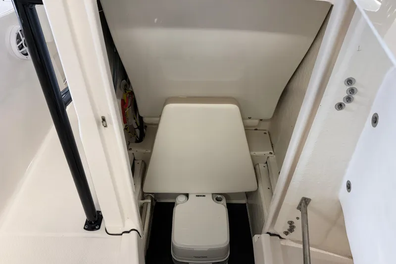 Slide: The Image of 2024 Robalo R202 Explorer boat interior with compact marine toilet. - 19