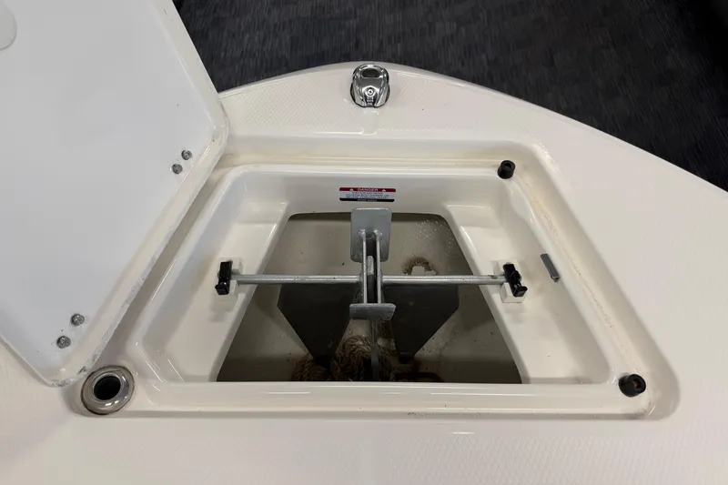 Slide: The Image of Anchor storage compartment on 2024 Robalo R202 Explorer boat, open lid view. - 22