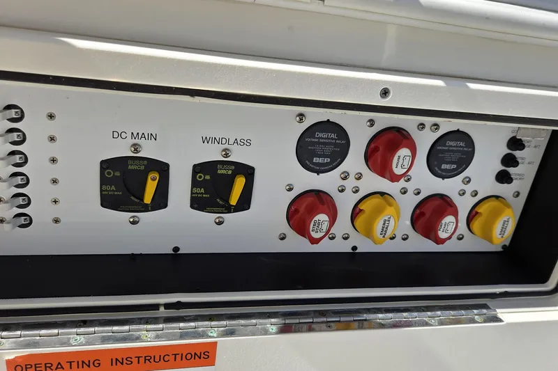 Slide: The Image of Control panel of a 2019 World Cat 295 CC boat with switches and circuit breakers. - 14