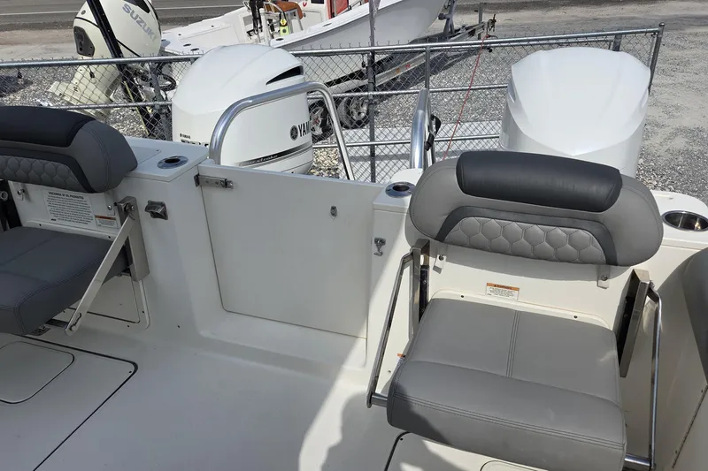 Slide: The Image of 2019 World Cat 295 CC boat interior with seating and Yamaha outboard engines. - 15