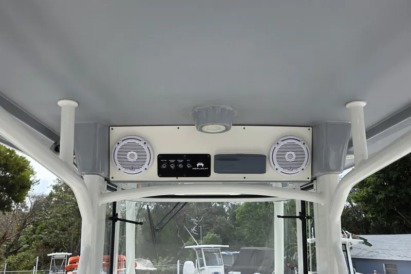 Slide: The Image of 2019 World Cat 295 CC boat interior with speakers and control panel. - 18