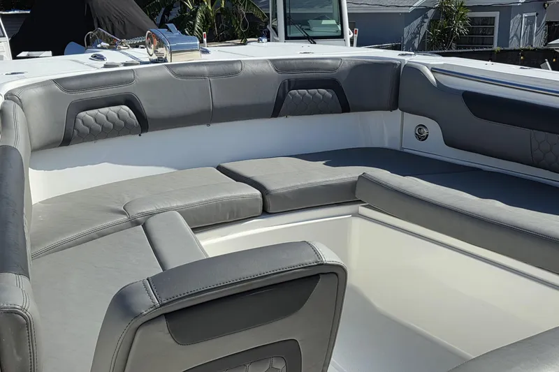 Slide: The Image of 2019 World Cat 295 CC boat interior with gray cushioned seating. - 2