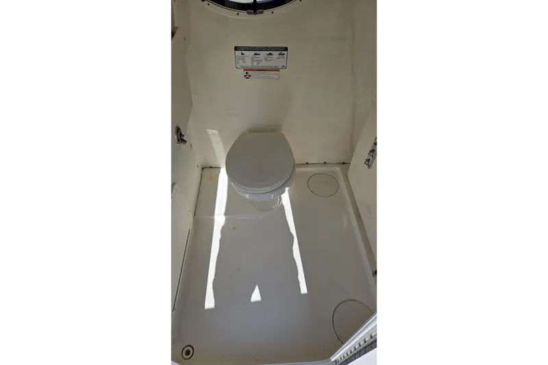 Slide: The Image of 2019 World Cat 295 CC boat interior with compact marine toilet. - 20