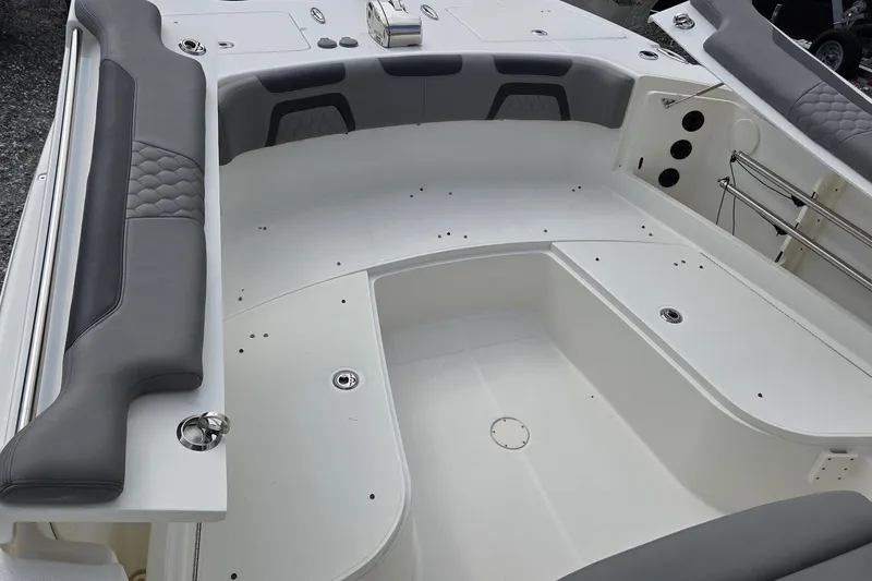 Slide: The Image of 2019 World Cat 295 CC boat interior with cushioned seating and storage compartments. - 21
