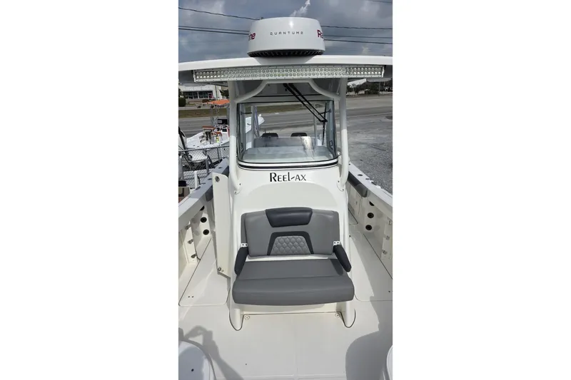 Slide: The Image of 2019 World Cat 295 CC boat with seating and console, featuring "Reelax" branding. - 22