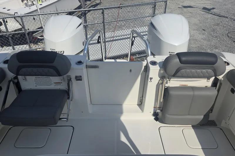 Slide: The Image of 2019 World Cat 295 CC boat interior with dual Yamaha engines and seating. - 23