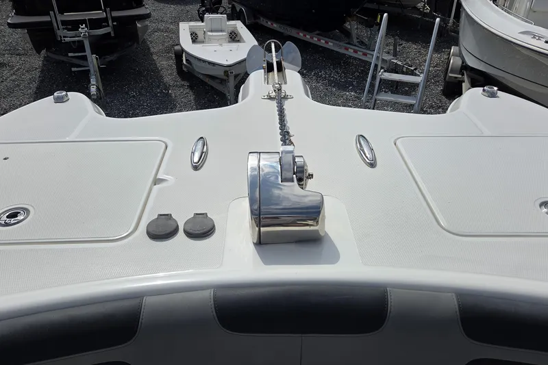 Slide: The Image of 2019 World Cat 295 CC boat deck with anchor chain and storage compartments. - 24