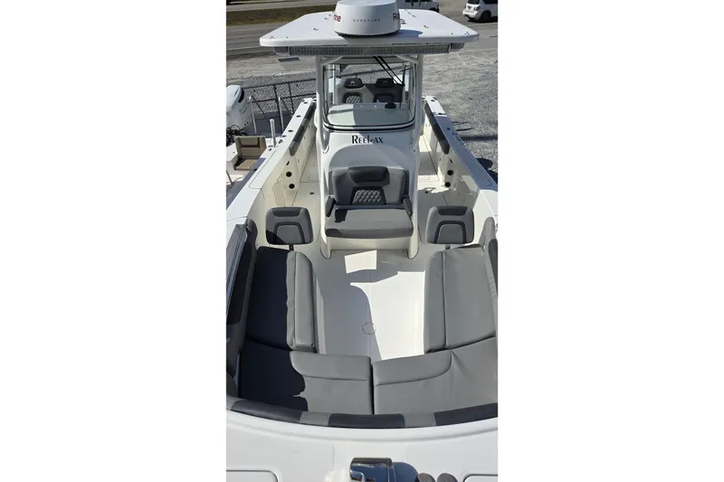 Slide: The Image of 2019 World Cat 295 CC boat interior with gray seating and center console. - 25