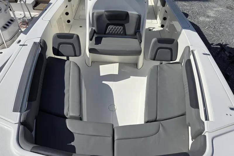 Slide: The Image of 2019 World Cat 295 CC boat interior with gray seating and spacious layout. - 26