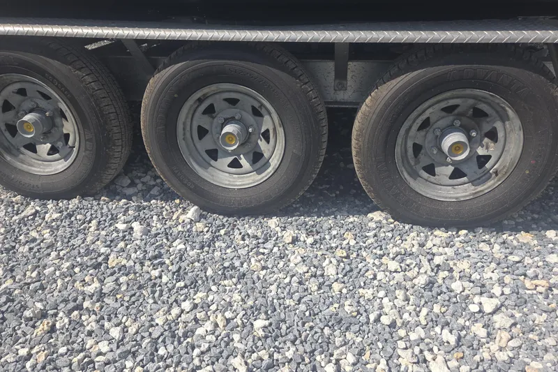 Slide: The Image of Trailer wheels on gravel for 2019 World Cat 295 CC boat. - 34