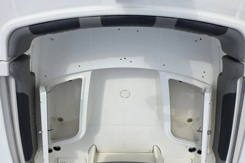 Slide: The Image of 2019 World Cat 295 CC boat interior with storage compartments and cushioned seating. - 4