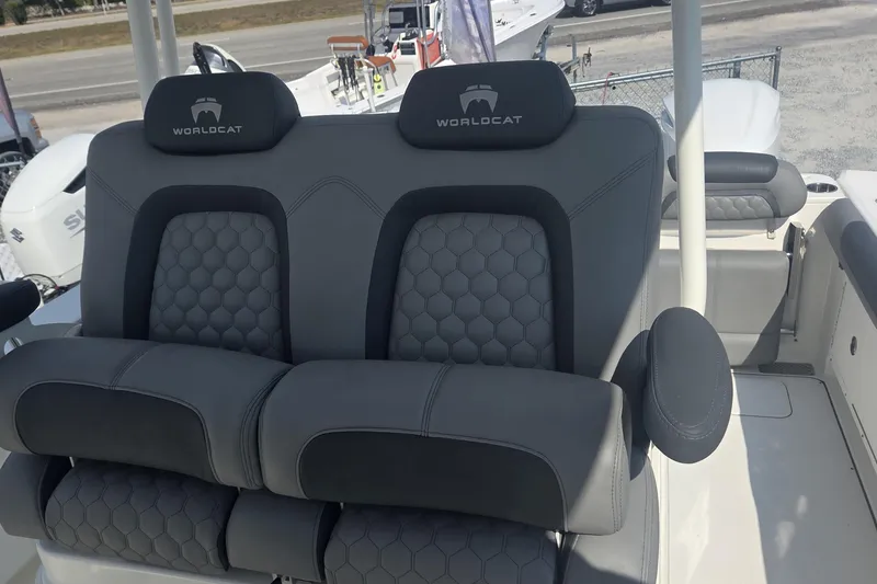 Slide: The Image of 2019 World Cat 295 CC boat seats with gray upholstery and armrests. - 6