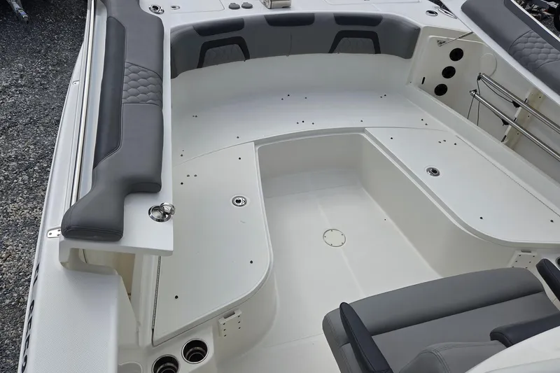 Slide: The Image of 2019 World Cat 295 CC boat interior with gray seating and spacious deck layout. - 9