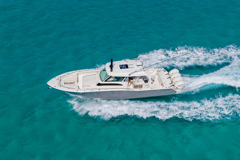 The Image of 2025 Grady-White Canyon 456 cruising on clear turquoise waters. - 0