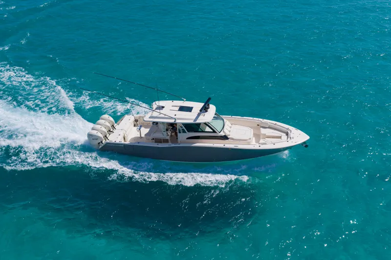 Slide: The Image of 2025 Grady-White Canyon 456 cruising on clear blue ocean waters. - 13