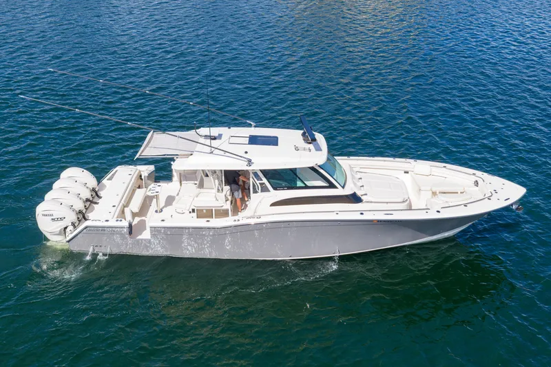 Slide: The Image of 2025 Grady-White Canyon 456 boat cruising on clear blue water. - 14